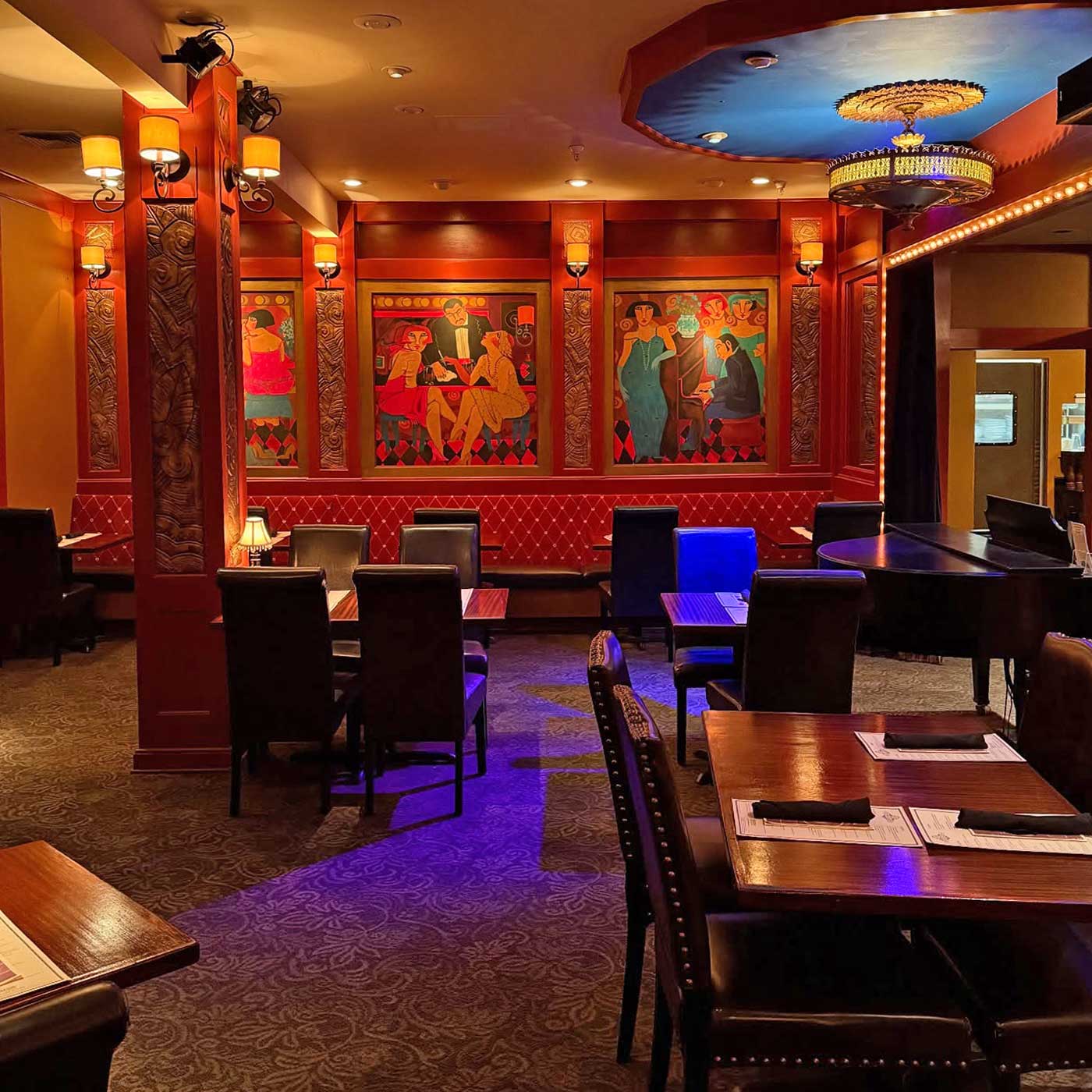 Hearsay Restaurant dining room filled with warm, glowing evening ambient lighting which highlights the colorful paintings